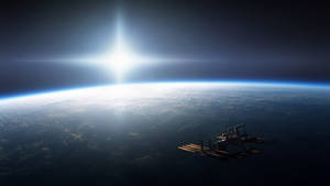 太空站繞地球運行，太陽在行星的曲線上方明亮地照耀。 — 光線 壁紙
