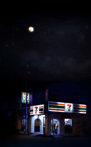 月光下的夜空，一個人站在7 Eleven便利商店入口處。 — 7-ELEVEN 壁紙