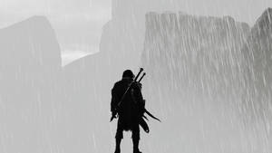 一個持劍的戰士站在山頂前的雨中。 — 中土世界：暗影魔多 壁紙