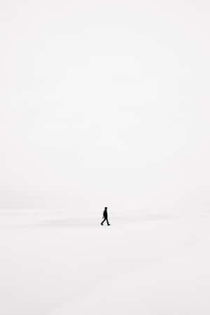 一個人獨自走過廣闊的雪景。 — 簡約暗黑美學 壁紙