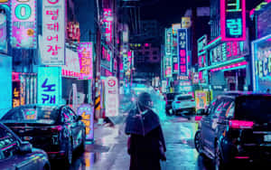 夜晚在霓虹燈閃爍的雨街撐傘行走的人。 — 惠普筆電 壁紙