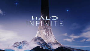 Halo Infinite標誌位於一個從雪山上出現的巨大環之上，時值黃昏。 — 最後一戰：無限 4K 壁紙
