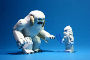 一個LEGO雪人人偶伸手去拿一個較小LEGO人偶手持的冰棒。 — MacBook Pro M3 壁紙