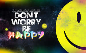太空中一個快樂的笑臉，旁邊有發光的訊息「Don't Worry Be Happy」。 — 喜悅 壁紙