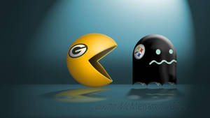 黃色 Pacman 和黑色鬼魂帶有 NFL 球隊標誌在聚光燈下對峙。 — 綠灣包裝工 壁紙