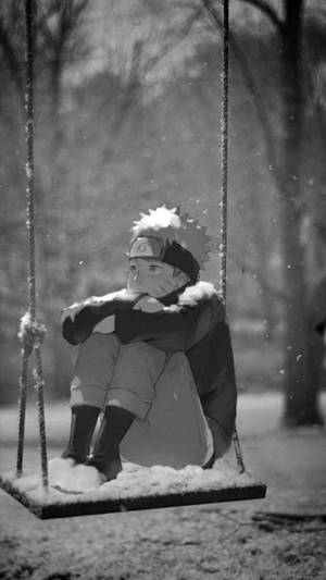 年輕動漫男孩坐在冬季公園被雪覆蓋的鞦韆上 — 火影忍者 佩恩 壁紙