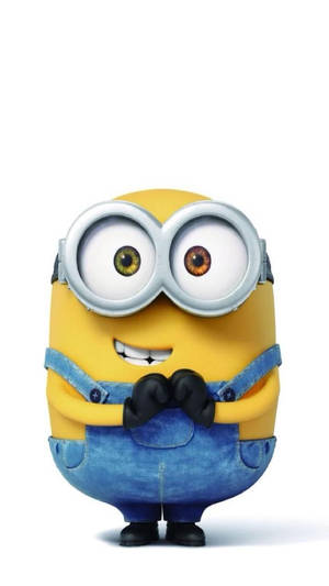 一個黃色卡通Minion戴著護目鏡和牛仔布工裝褲微笑。 — 可愛猴子 壁紙