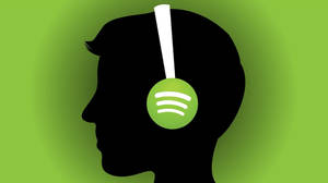 戴著耳機的人，耳罩上有Spotify標誌，綠色背景 — Spotify 壁紙