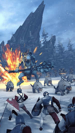 巨人戰士手持火焰武器在雪地山景中與騎士和野豬戰鬥。 — 全軍破敵 戰錘 壁紙