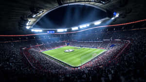 一個燈火通明的足球場，在夜間比賽中擠滿了歡呼的球迷。 — FIFA 世界盃 壁紙