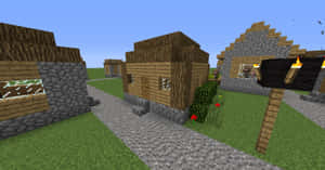 Minecraft村莊，有木屋和石屋、鵝卵石小徑和火把。 — 可愛 Minecraft 壁紙