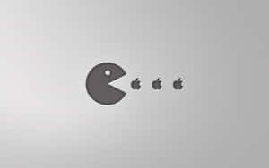 Pac-Man 在銀色表面上吃 Apple 標誌。 — 蘋果 壁紙