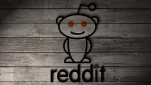 灰色木背景上的Reddit外星人標誌，附有文字reddit — 低調 壁紙