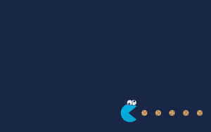 藍色 Pac-Man 在深藍色背景上追逐餅乾。 — 餅乾怪獸 壁紙