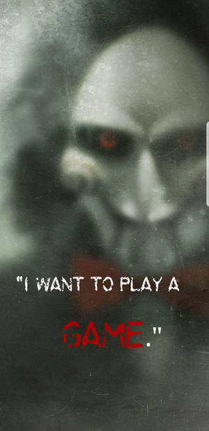 一個帶有發光紅色眼睛的鬼影，凝視著文字「I WANT TO PLAY A GAME。」 — 恐怖反派 壁紙