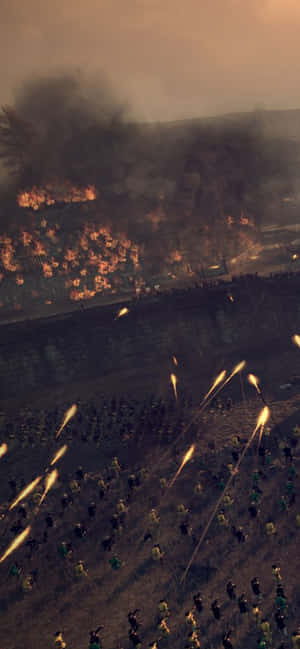 士兵在黃昏時穿過被火焰和煙霧吞噬的戰場前進。 — 電玩遊戲 GIF 壁紙