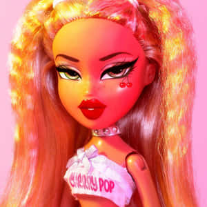 一個擁有橙色頭髮和櫻桃臉頰裝飾的娃娃，穿著「Cherry Pop」上衣。 — Bratz 美學 GIF 壁紙