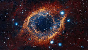 一個充滿活力的宇宙星雲，帶有發光橙色氣體和明亮的藍色恆星。 — 宇宙 壁紙