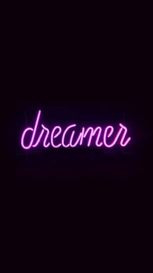 粉紅色霓虹燈牌，上面寫著夢想家，背景為黑色。