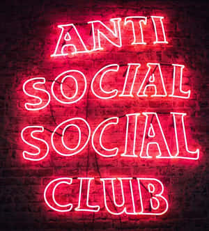 磚牆上寫著 Anti Social Social Club 的紅色霓虹燈牌。 — 榮耀Magic V Flip 2 壁紙