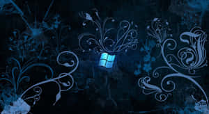 Windows標誌，帶有華麗的藍色花卉設計，背景為深色紋理。 — Windows 11 4K 壁紙