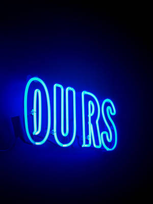 藍色霓虹燈牌顯示「OURS」，在深色牆壁上發光。 — 霓虹 壁紙