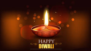 一個點亮的迪亞燈，帶有裝飾圖案和發光的文字，寫著 Happy Diwali。 — 三島一八 壁紙