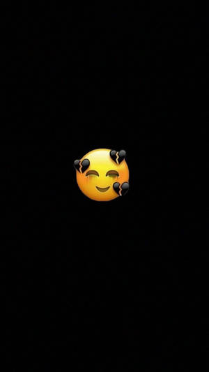 一個帶有破裂角的惡魔表情符號在黑色背景上微笑。 — 難過表情符號 壁紙
