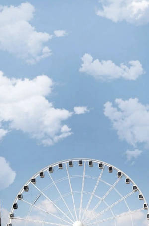 藍天下白色摩天輪與散落的雲朵。 — 美學天空 壁紙