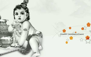 嬰兒克里希納佩戴珠寶，旁邊有儀式物品，帶有「Happy Janmashtami」文字和橙色花朵。 — 印度 壁紙