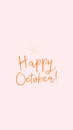 在桃色背景上用橙色草書寫的 Happy October 訊息，附有一個小蝴蝶結。 — 十月 壁紙