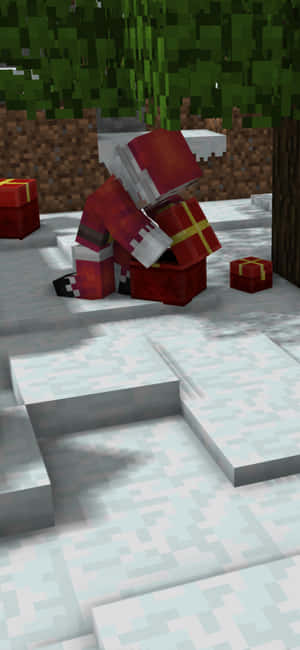 Minecraft像素藝術中的聖誕老人坐在雪地上，附近有禮物盒。 — Galaxy S24 FE 壁紙