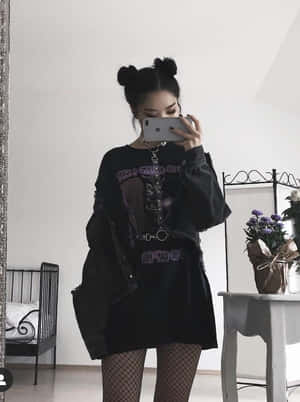 綁著雙丸子頭的人穿著黑色衣服和魚網絲襪對著鏡子自拍。 — 垃圾美學 壁紙