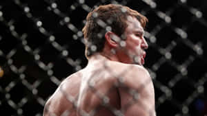 一個赤裸上身的戰士在MMA八角籠中展現高度專注。 — 運動 壁紙