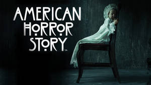 一個鬼魅的小孩穿著白色裙子坐在黑暗房間的椅子上，有 American Horror Story 文字。 — 美國恐怖故事 壁紙