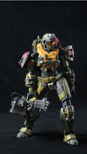 Halo Spartan動作人偶，身穿金色和黑色盔甲，手持武器。 — 暗黑破壞神 壁紙