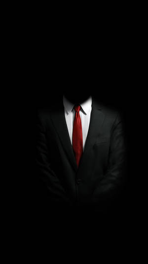 身穿黑色西裝和紅色領帶的無面男子站在黑暗中。 — 男人 壁紙
