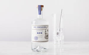 一個 St George Botanivore Gin 酒瓶和雞尾酒調酒器放在白色大理石表面上。 — 品牌 壁紙