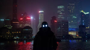 一個人的剪影，眼睛發光，背景是夜晚充滿活力的城市天際線。 — 夜景城市 壁紙
