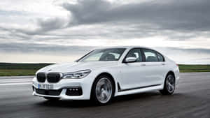 白色BMW 7系列轎車在多雲天空下行駛在高速公路上。 — Mercedes Benz C300 壁紙