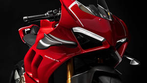 紅色 Ducati Panigale V4R 運動摩托車，帶有碳纖維細節和金色前叉。 — 杜卡迪 GIF 壁紙