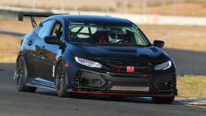 日落時分賽道上的黑色本田Civic Type R賽車。 — 1600x900 壁紙