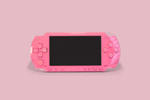 純粉紅背景上的粉紅色 PlayStation Portable 遊戲主機 — MacBook Air 壁紙