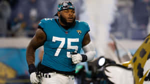 身穿青綠色75號球衣的足球員在場上奔跑。 — NFL 美式足球 壁紙