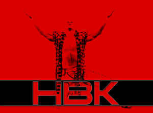 摔角手 HBK 戴鎖鏈舉臂於紅色背景上。 — 摔角 壁紙