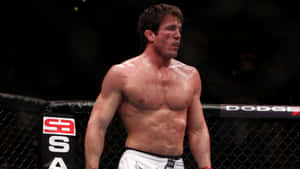 一名男性MMA拳手在比賽中站在八角籠內。 — 運動 壁紙