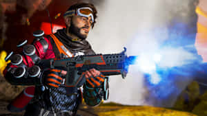 士兵發射帶有藍色槍口閃光和煙霧的未來武器。 — Studio Display 壁紙