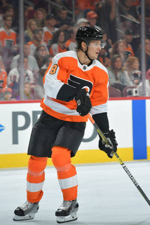 曲棍球運動員在比賽中滑行，背景有觀眾 — 運動 壁紙
