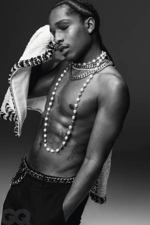 一名戴著鏈條和珍珠的時尚男子，肩上搭著毛巾擺姿勢。 — ASAP Rocky 壁紙