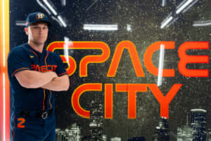 身穿太空人隊球衣的棒球運動員夜晚站在「Space City」霓虹標誌前。 — 暮光 壁紙